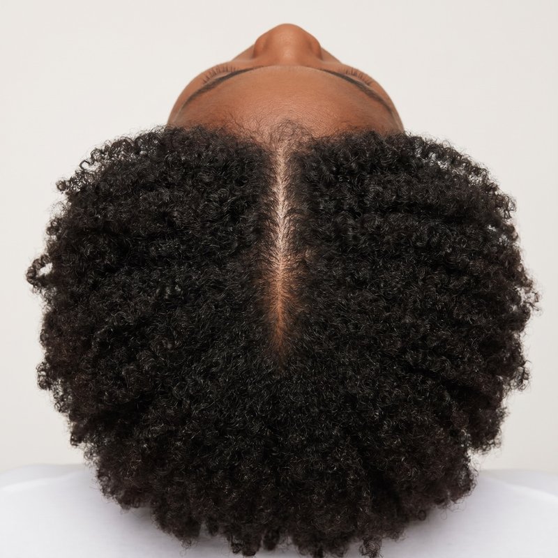 Top-down view of a healthy, full part line on a Black woman
